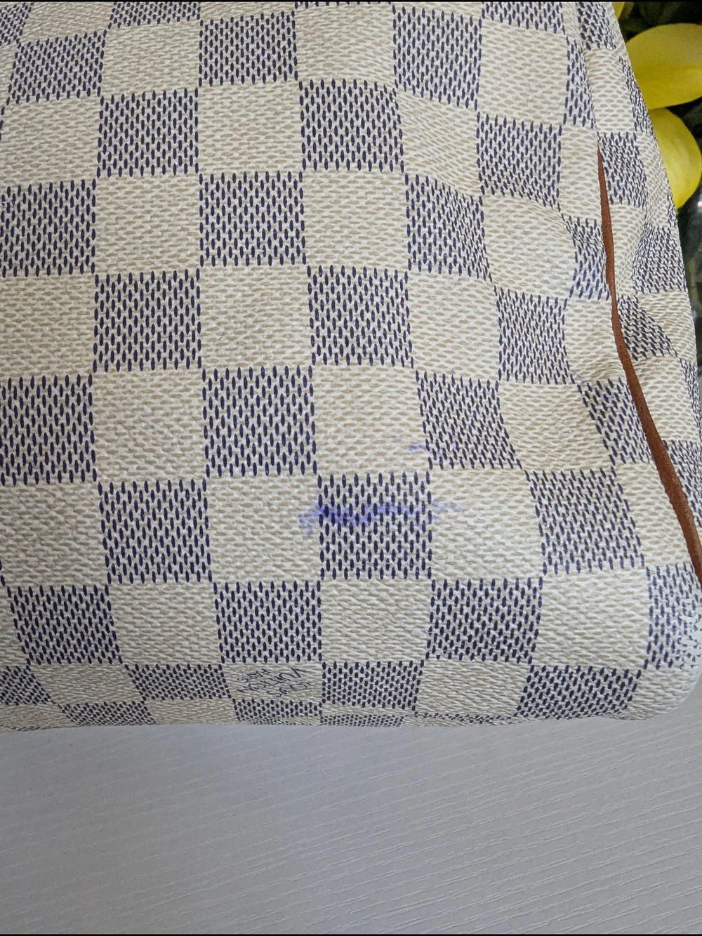 Louis Vuitton Speedyhandbag styled in the iconic Damier Azur canvas pattern.
